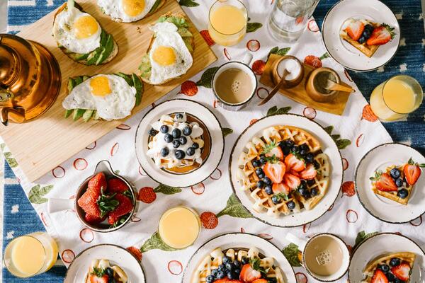 Aerial view of breakfast pancakes, waffles, and eggs