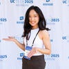 Attendee smiling in front of the UC Tech backdrop.