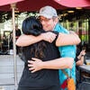 Attendees hugging each other.