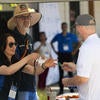 Volunteers passing out swag to attendees.