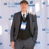 Attendee smiling in front of the UC Tech backdrop.
