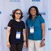 Attendees smiling in front of the UC Tech backdrop.