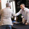 Attendee talking to sponsor representative at their booth.