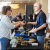 Attendees getting their swag at the registration check-in booth.