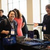 Attendee talking to a sponsor representative at their booth.