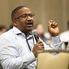 Attendee holding a microphone and asking a question.