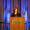 UC Tech Awards emcee, Laurel Skurko, speaking at the podium.