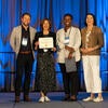 UC Tech Awardee smiling at the camera with UC CIOs.