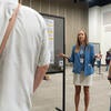 Poster presenter speaking to attendees.