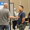 Poster presenter speaking to attendees.