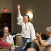 Attendee raising their arm after winning a raffle prize.