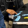 Attendee reading their raffle ticket numbers.