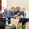 Attendee smiling with their raffle prizes.