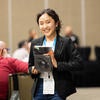 Attendee smiling with their raffle prize.