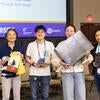 A group of winning attendees holding their raffle prizes.